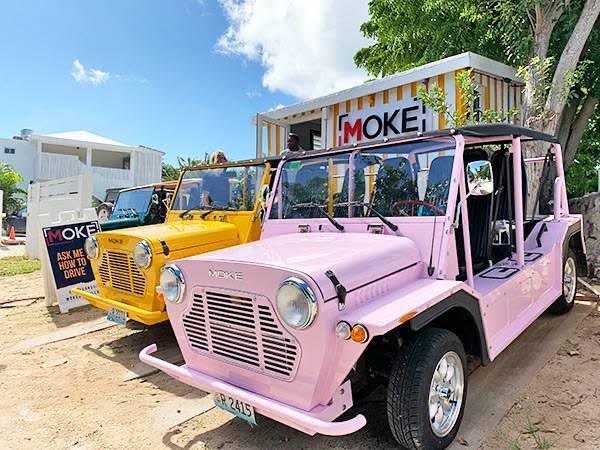 Real pink Moke cars lined up in the Bahamas