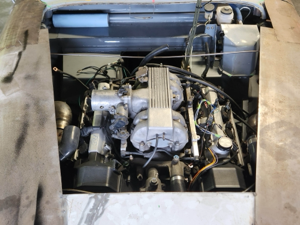 A detailed view of the engine bay of a home-built custom project car.